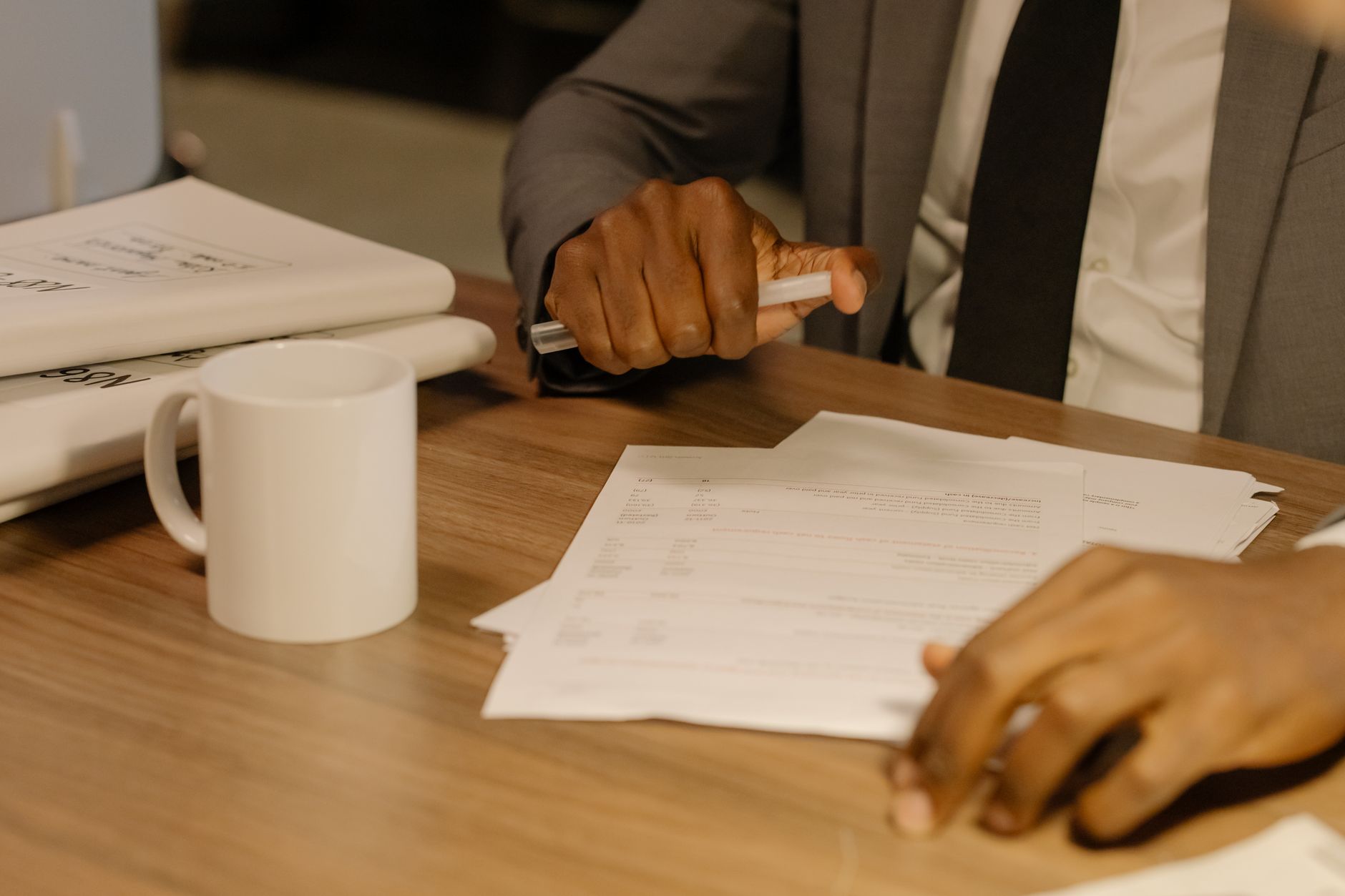 A staff member reviewing documents at a desk — casino verification is mostly manual and creates a queue